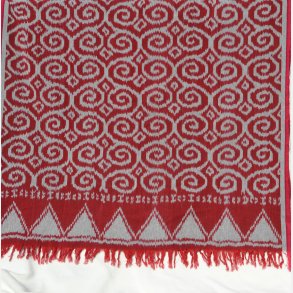 Ikat tekstil med snirkler - rd og gr